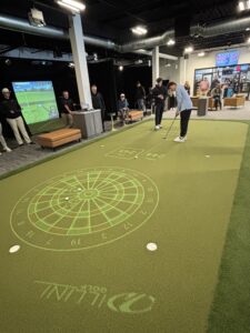 Customers practice their putts on the PuttView putting simulator