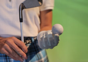 Golfer prepares for swing on green background holding a golf ball, golf shop Morton IL, golf store near Morton IL, golf clubs Morton IL, golf equipment Morton IL, golf pro shop Morton IL, custom club fitting Morton IL, golf simulator Morton IL, indoor golf Morton IL, used golf clubs Morton IL, golf club fitting near Morton IL, golf accessories Morton IL, buy golf clubs Morton IL, golf lessons Morton IL, club repair Morton IL, golf balls Morton IL, golf apparel Morton IL, boutique golf store Illinois, local golf store Morton, golf store Central Illinois